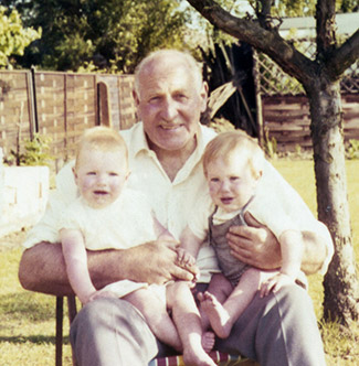 My Granddad, Jim Ewing, with his two eldest grandchildren, me (right) and my cousin, in Reading, c.1970